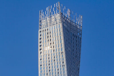 Low angle view of modern building against clear blue sky