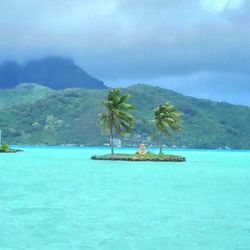 Scenic view of sea with mountains in background