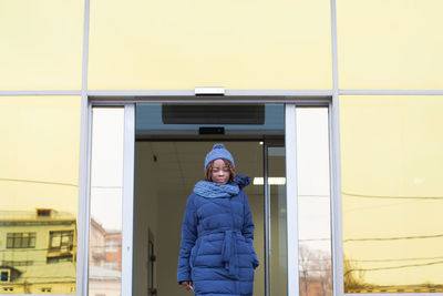 Portrait of smiling woman standing in snow