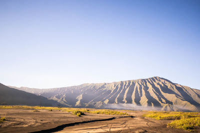 Scenic view of mountains against clear blue sky