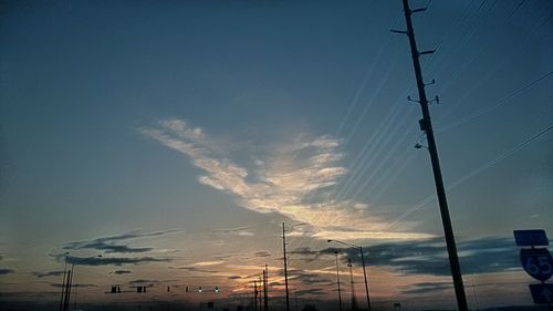 Low angle view of electricity pylon against sky