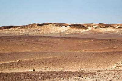 Scenic view of desert against clear sky