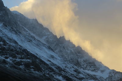 Scenic view of snowcapped mountains against sky during sunset