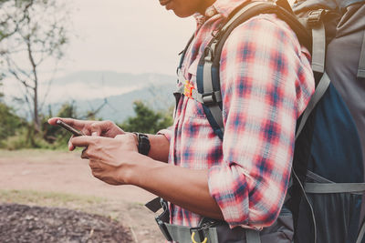 Midsection of woman holding mobile phone