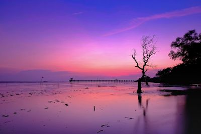 Scenic view of sea against orange sky