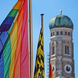 Low angle view of flags on building against sky