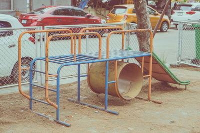 Empty chairs on street in city