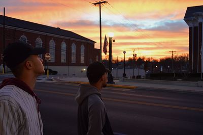 Men on street in city against sky