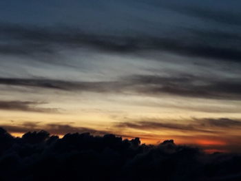 Scenic view of silhouette mountains against dramatic sky