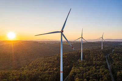 Germany, baden-wurttemberg, aerial view of wind farm at sunrise