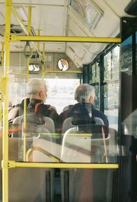 Rear view of people sitting in bus