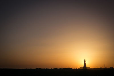 Silhouette landscape against clear sky