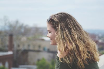 Close-up of smiling teenage girl with blond hair