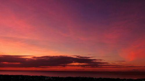 Scenic view of sea against romantic sky at sunset