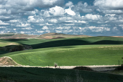 Scenic view of landscape against cloudy sky