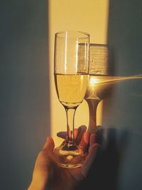 Midsection of man holding wine glass