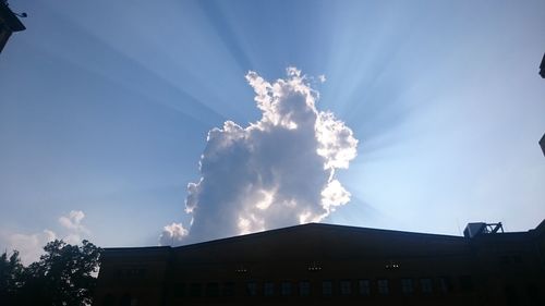 Low angle view of building against cloudy sky