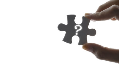 Close-up of hand holding hands over white background