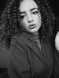 Portrait of beautiful young woman with curly hair