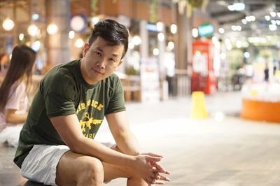 Portrait of man sitting in shopping mall