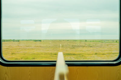 Scenic view of landscape through a train window