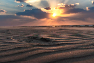 Scenic view of beach against sky during sunset