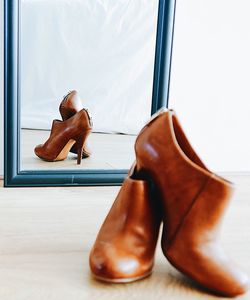 Close-up of heels and their reflection in the mirror