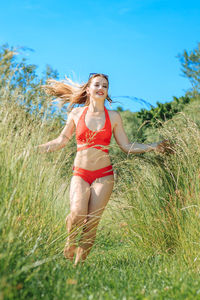 Full length of woman on field against sky