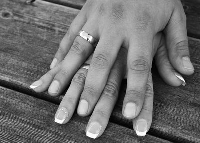 Cropped image of couple holding hands on table 