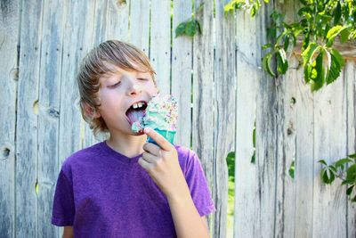 Close-up of smiling boy eating ice cream