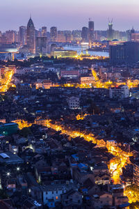 High angle view of city lit up at dusk