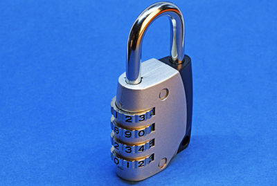 Close-up of padlocks against blue background