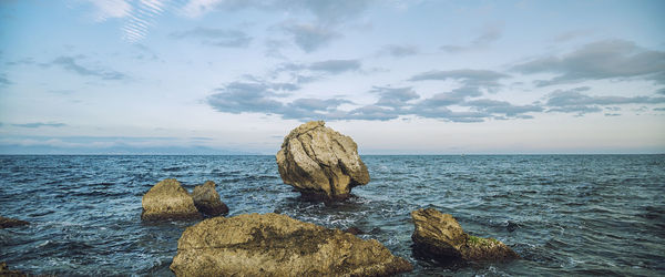 Scenic view of sea against cloudy sky