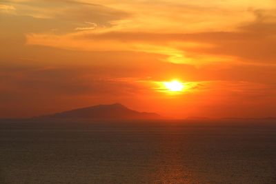 Scenic view of sea against romantic sky at sunset