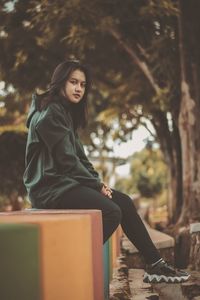 Portrait of woman sitting outdoors