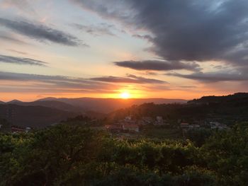 Scenic view of townscape against sky during sunset