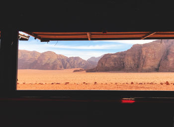 Scenic view of mountains seen through window