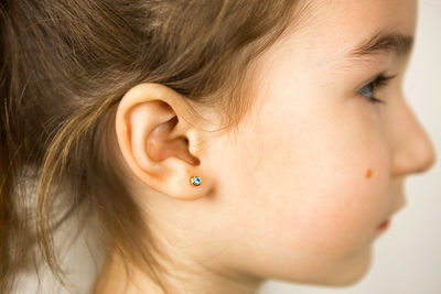 Close-up girl looking away against white background