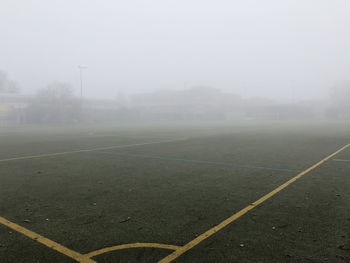 Scenic view of field against sky during foggy weather