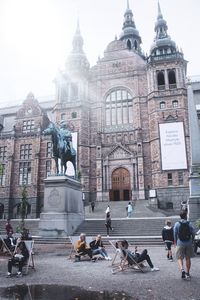 Group of people in front of historic building