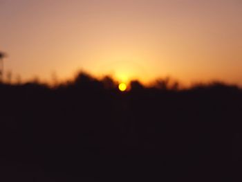 Scenic view of silhouette landscape against clear sky during sunset