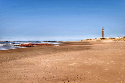 Scenic view of sea against clear blue sky