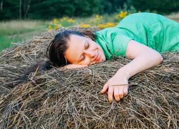 Young woman on haystack.