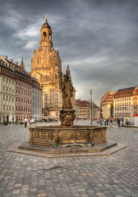 Sculpture of buildings against cloudy sky