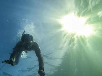 Low angle view of man swimming in sea