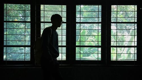 Man standing by window