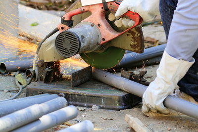 Low section of worker cutting metal