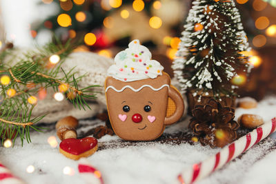 Christmas gingerbread cookie and decorations at christmas tree, gingerbread cup. high quality photo