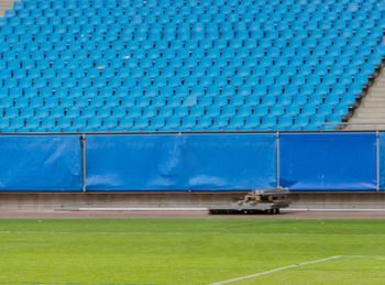 View of green field against blue wall