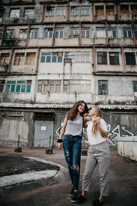 Full length of young woman standing in city